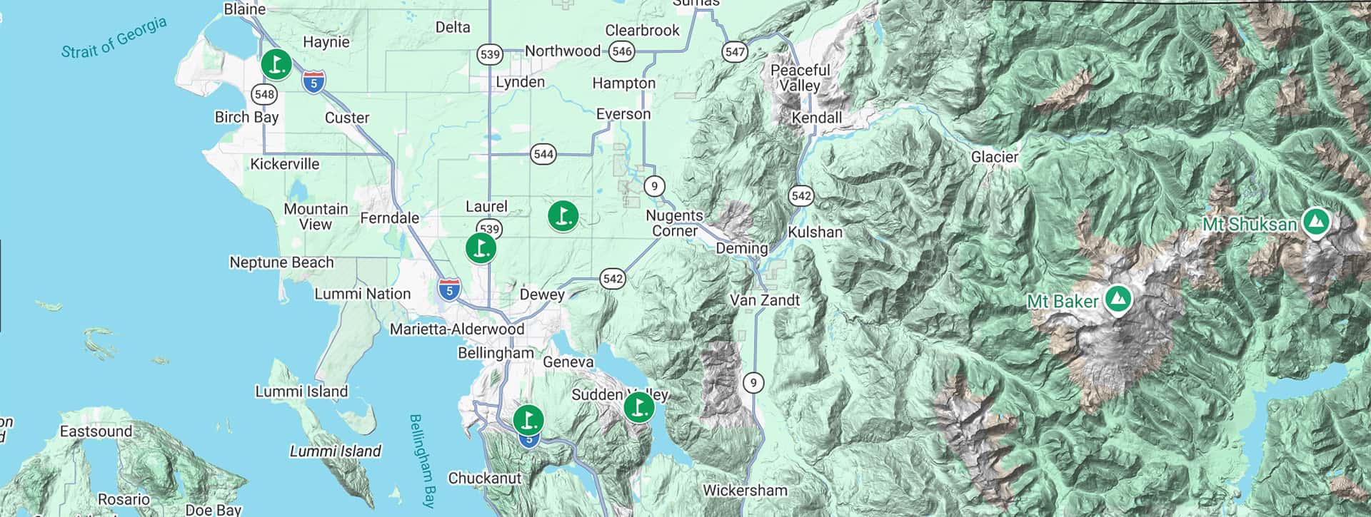 Map showing parts of northwestern Washington State, including cities like Bellingham and Mount Baker. Various icons mark notable outdoor locations and parks, with mountains and green terrain visible to the east.